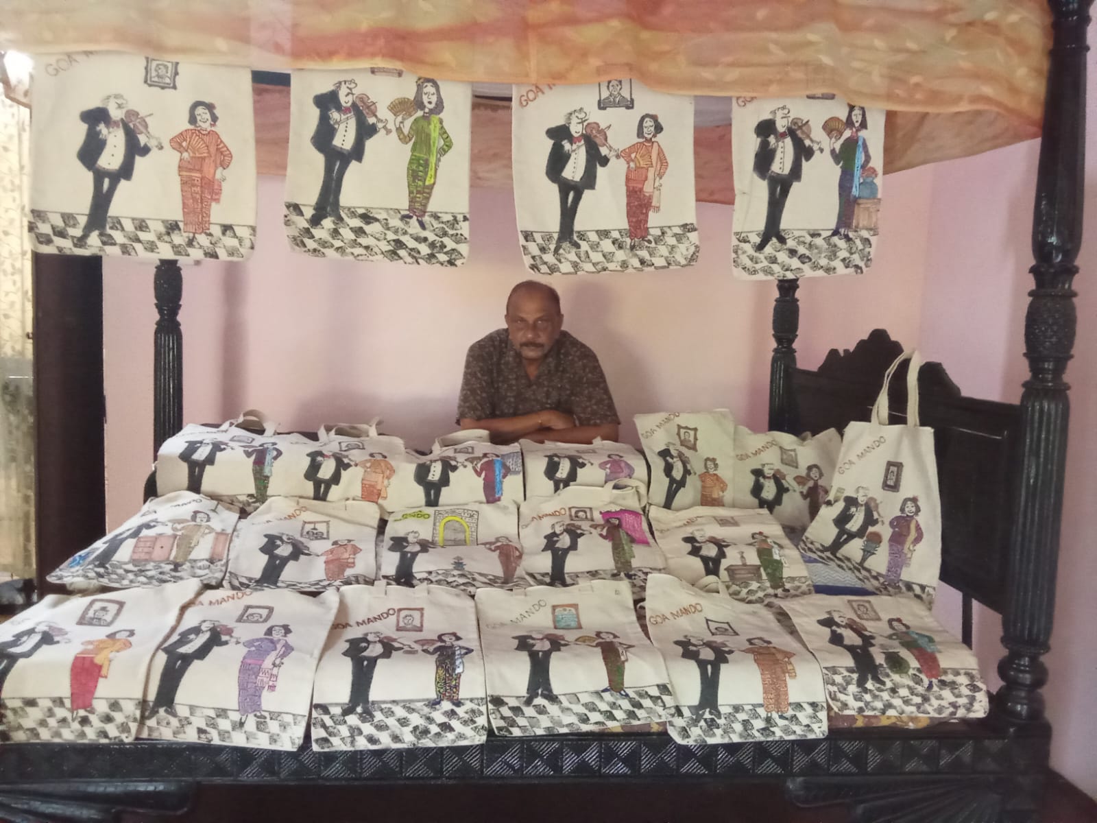 Irwin Antao with his full collection of hand-drawn tote bags
